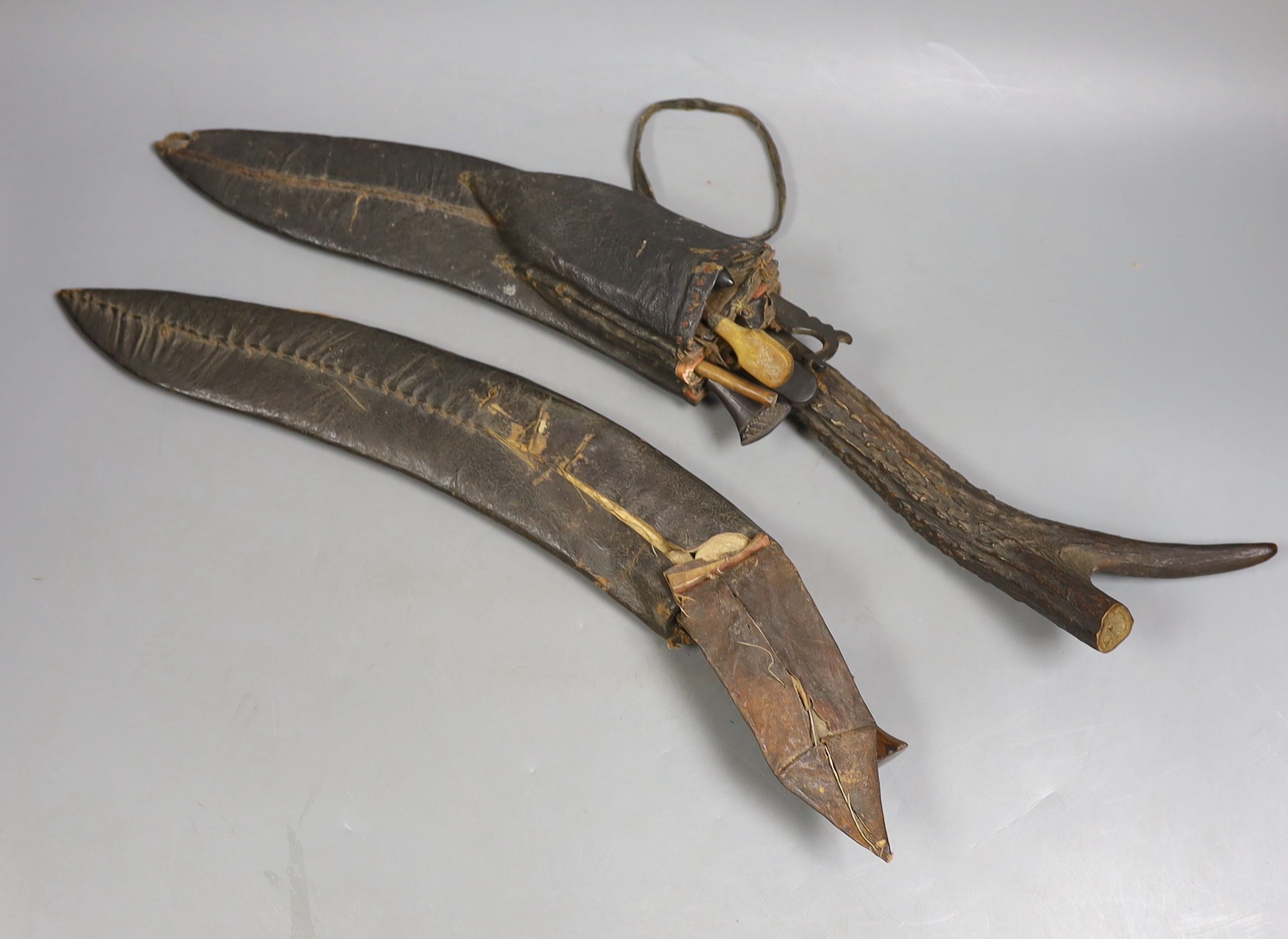 Two Nepalese kukri knives, antler handle knife 55cms long.